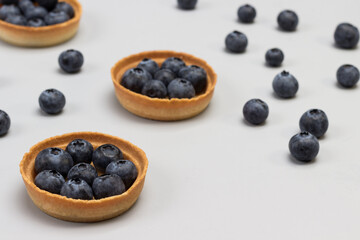 Tartlets with blueberries. Blueberries on table