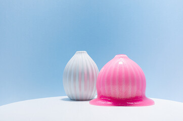 Pink slime with gold glowing glitter cover and flow down white vase in puddle. Modern abstract fun...