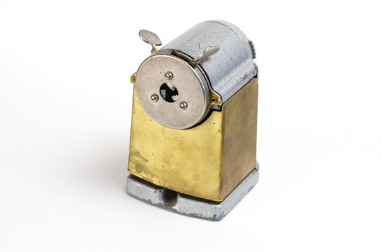 Vintage Pencil Sharpener On White Background. Manual Metal Tool For Sharpening Wooden Pencils.