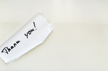 Thank you - A handwritten note floats in the white water. A piece of paper with wet edges. Words of gratitude.