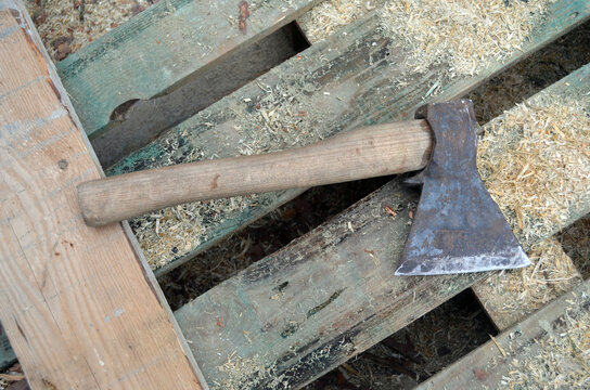 Photography on theme big steel axe with wooden handle, metal ax for wood chopping. Photo old ax consisting of one axe on nature background. Forged axe it main accessory male, natural ax for survival.