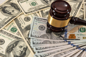 dollar money and judges gavel on table