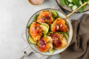 Baked chicken thighs marinated with butter, honey and mustard and baked  with spring peas, capers,...