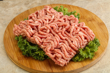 Raw pork minced meat over board