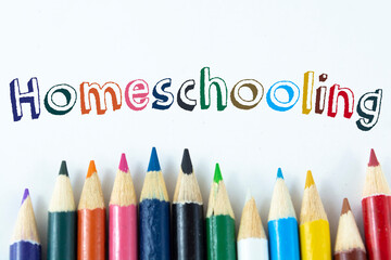 Pencil Crayons with text Homeschooling isolated over white