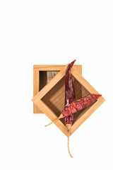 Sun dried red pepper arranged in wooden blocks on a white background