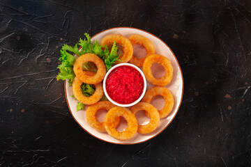 Calamari rings. Deep fried squid rings with green salad and ketchup, top shot