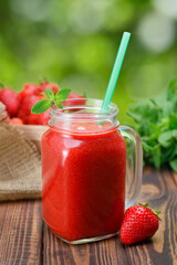 strawberry cocktail in glass mason jar outdoors
