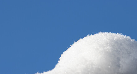 Winter snow on a background of blue sky.