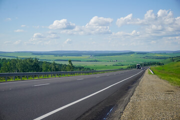 The road in Siberia at the beginning of summer