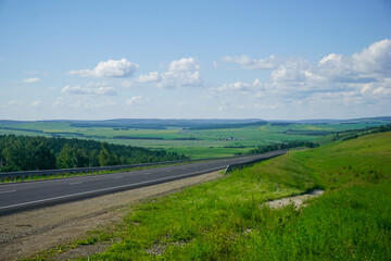 The road in Siberia at the beginning of summer