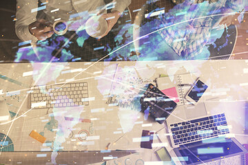 Double exposure of man and woman working together and data theme hologram drawing. Computer background. Top View.