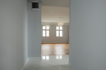 Interior of an empty apartment with parquet and marble floor