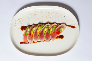 Tuna fish tataki served with a citrus-soy dipping sauce