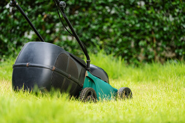 lawn mower on green grass at home