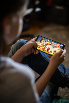 Illustrative editorial image of child playing Clash of Clans mobile game