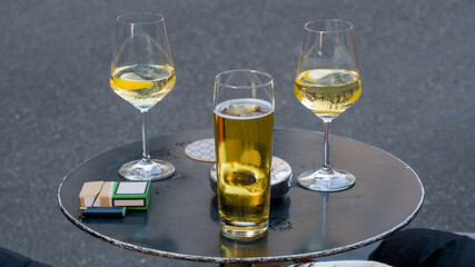Beer and wine glasses on table in the street 