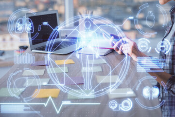 Naklejka premium Double exposure of woman hands typing on computer and general theme hologram drawing. Education concept.