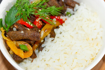 Roast beef with sweet pepper and white rice. Close up