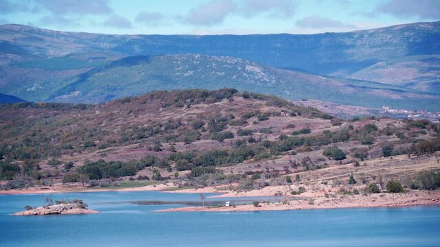 Caravan on lake shore, embalse de Aguilar de Campoo in province of Palencia, Castile and Leon community, northern Spain.