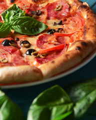 Fresh italian pizza with salami and black olives. Traditional Italian pizza recipe, Italian cuisine.