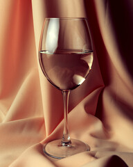 Wine collection - White wine in glass over golden background.