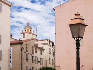a street light against the backdrop of scenic Ajaccio, Corsica. Sky, clouds, and pink colors