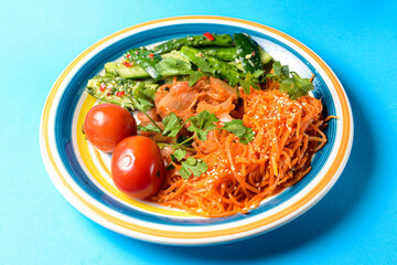 Fresh vegetable salad made of cabagge, carrot, cucumbers and tomatoes with fresh greenery.