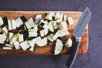 chopped eggplant cubes on cutting board, simple ingredients concept