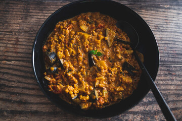 vegan eggplant lentil curry with tomato sauce and coconut milk, healthy plant-based food