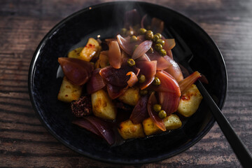 vegan roasted potatoes and beetrrot wedges with onion sauce, healthy plant-based food