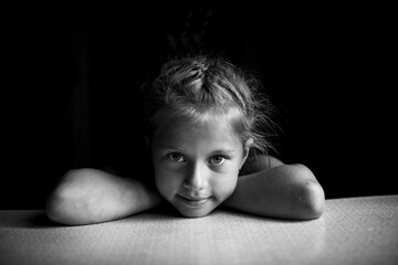 Portrait of little girl close up. Black and white photo.