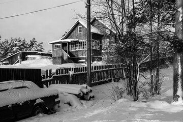 Rural typical house, in winter in the Republic of Karelia, Russia. Black and white photo.
