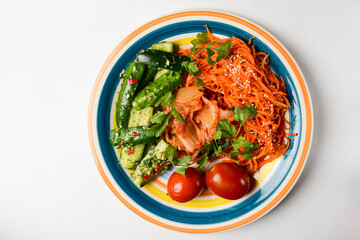 Fresh vegetable salad made of cabagge, carrot, cucumbers and tomatoes with fresh greenery.