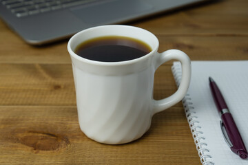 A cup of coffee on the desktop. Coffee break, morning and relax.