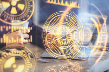 Double exposure of man's hands holding and using a digital device and tech theme hologram drawing. Technology concept.