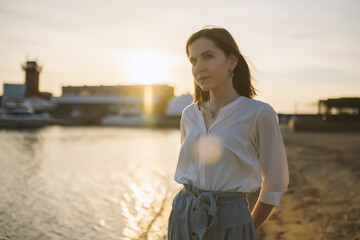 Woman in dress enjoys the sea shore.
