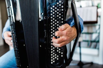 Detail of a musician's hand playing the accordion.