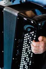 Detail of a musician's hand playing the accordion.