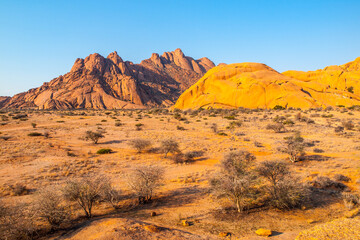Pontok Mountains near Spitzkoppe. Red vivid granite rock formation in Namib Desert at sunset time, Namibia, Africa