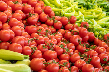 Varieties of vegetables sold at the grocery store. Tomatoes, zucchini, peppers. Food background