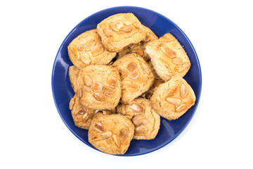 Spanish almond cookies, Almendrados from Mallorca on plate  Isolated on white background.