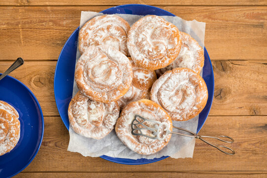 Spanish Ensaimadas spiral pastry on rustic table top view