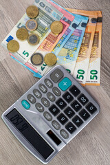 euro money of different denominations and calculator