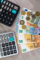 euro money of different denominations and calculators
