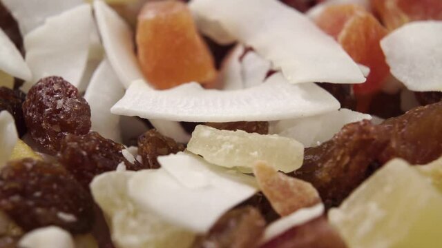 Dried pieces of tropical fruits. Macro shot. Rotation. Vitamin fruit mixture
