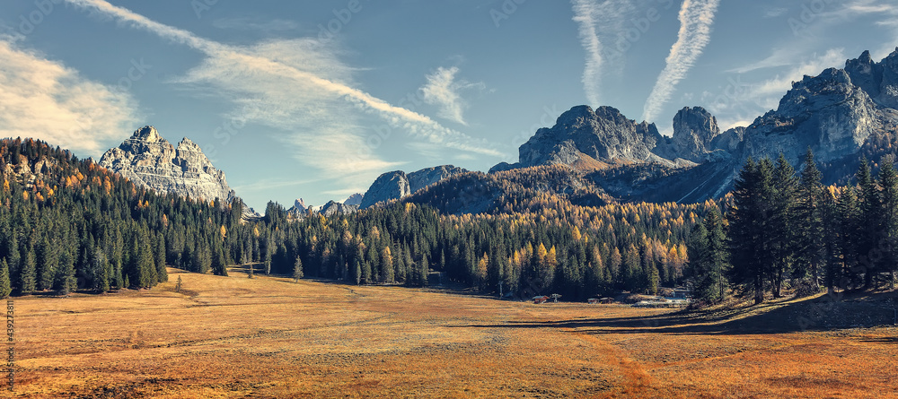 Fototapete Awesome alpine highlands in sunny day. Scenic image of fairy-tale autumn Landscape in sunlit with Majestic Rock Mountain on background. Wild area. Tre cime di Lavaredo. Dolomites Alps. Italy