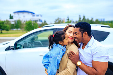 latin hispanic man and beautiful woman with cute daughter ready for trip on car
