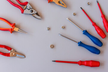 Flat lay of set of tools for car repairing and home maintenance on grey background. Top view.