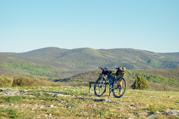 Bicycle equipped with bikepacking stuff in the mountains